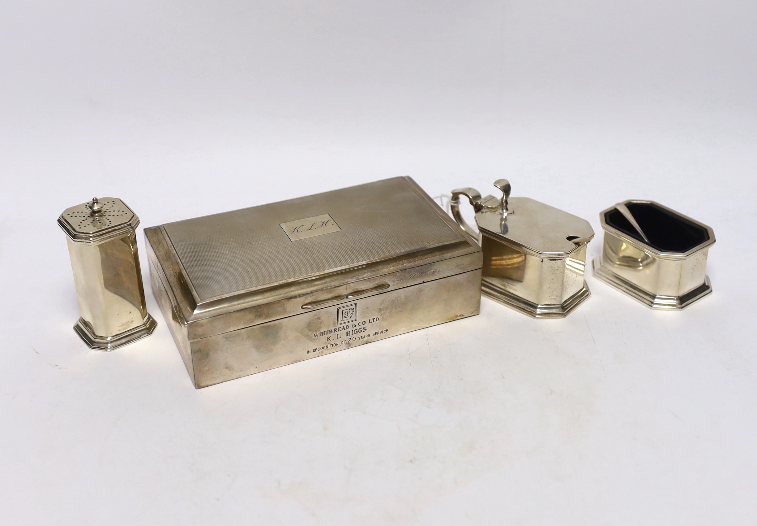 A modern silver mounted rectangular cigarette box, 17.1cm and a George VI three piece silver condiment set 1936/7 & 1941.